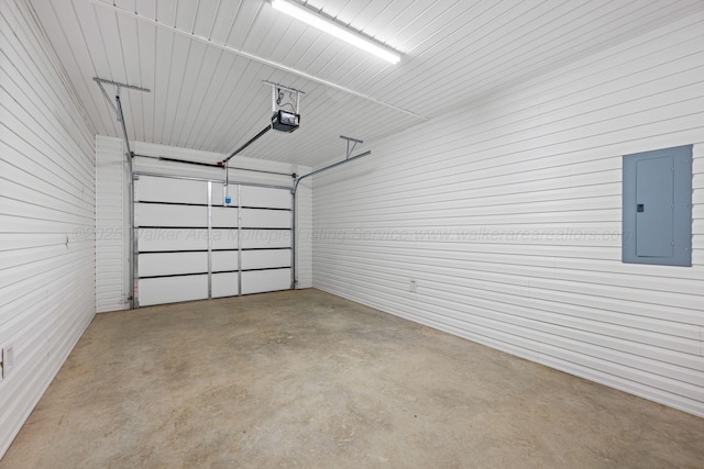 garage featuring a garage door opener and electric panel