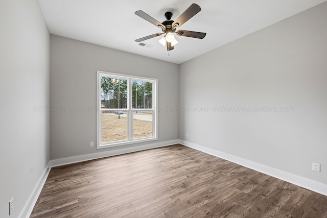 spare room featuring hardwood / wood-style floors and ceiling fan