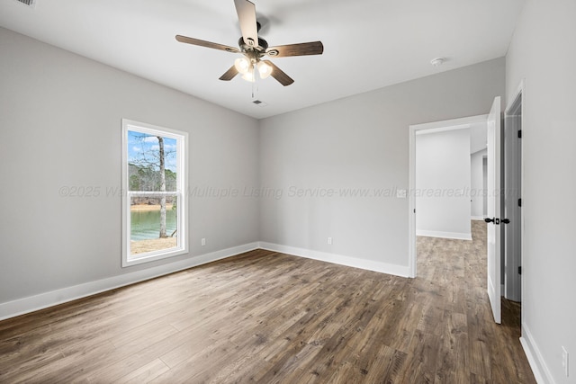 empty room featuring wood-type flooring and ceiling fan