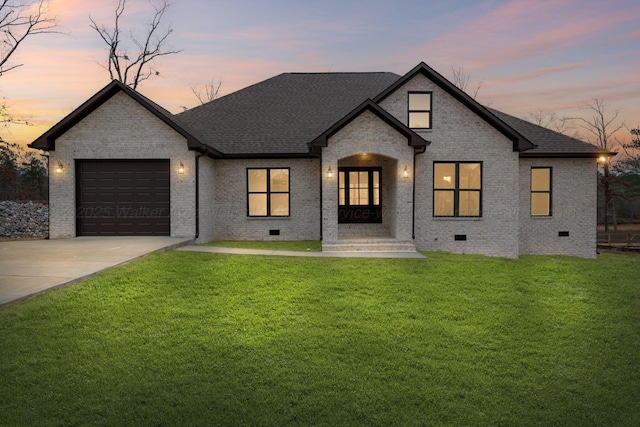 french country inspired facade with a garage and a lawn