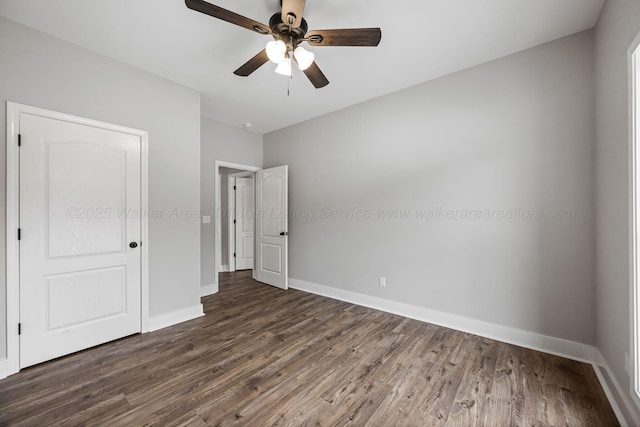 unfurnished bedroom with ceiling fan and dark hardwood / wood-style flooring