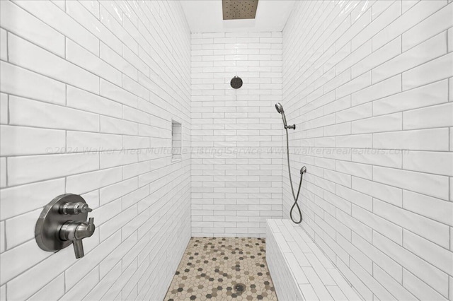 bathroom with tiled shower