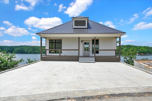 view of front facade with a water view and a porch