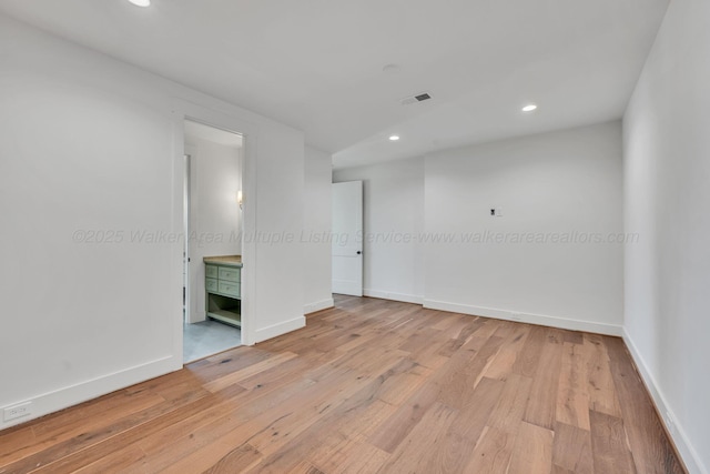 spare room featuring baseboards, recessed lighting, visible vents, and light wood-style floors