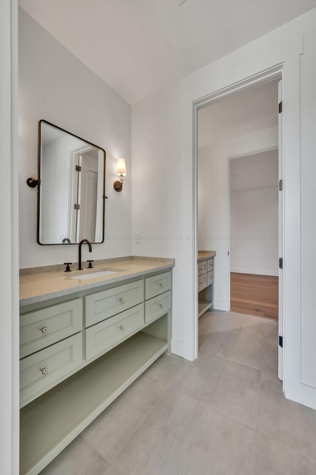 bathroom featuring tile patterned flooring, vanity, and baseboards