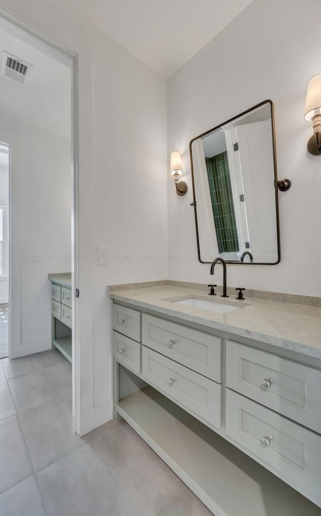 bathroom with tile patterned flooring, visible vents, and vanity