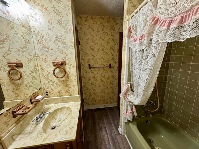 bathroom featuring vanity, shower / bath combination with curtain, a textured ceiling, and hardwood / wood-style floors