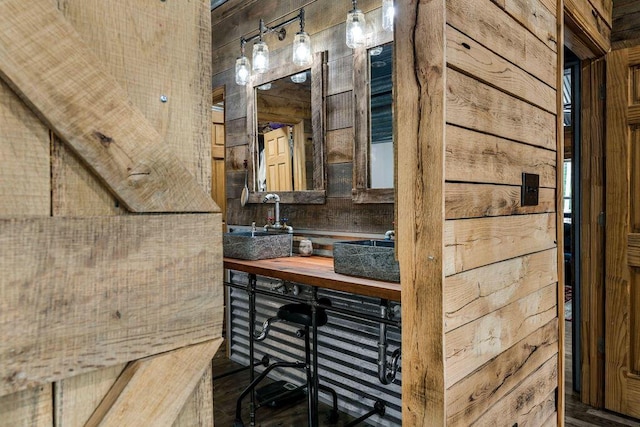 bathroom featuring vanity and wooden walls