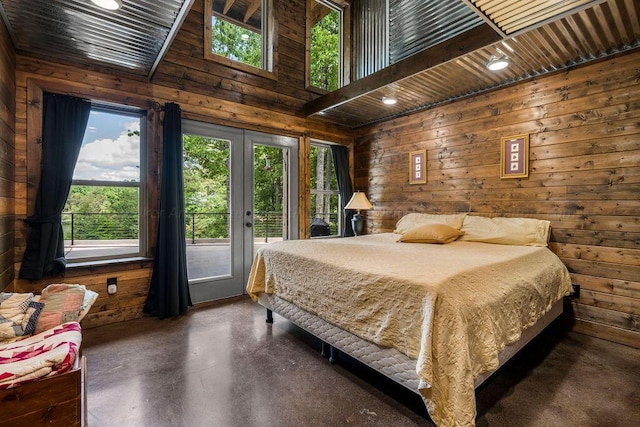 bedroom with multiple windows and wooden walls