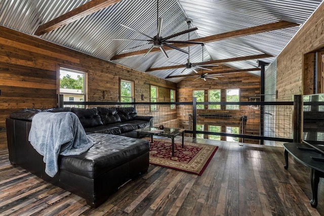 living room featuring beam ceiling, wooden walls, high vaulted ceiling, and hardwood / wood-style flooring