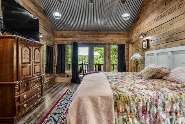 bedroom featuring dark hardwood / wood-style flooring, access to outside, vaulted ceiling, and wood walls