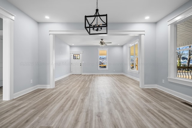 unfurnished dining area featuring ceiling fan and light wood-type flooring