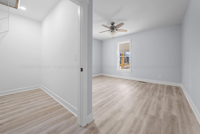 spare room with ceiling fan and light wood-type flooring