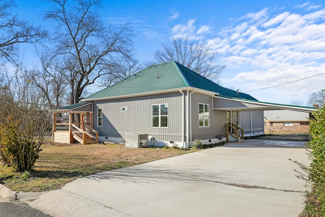 view of side of home with a carport