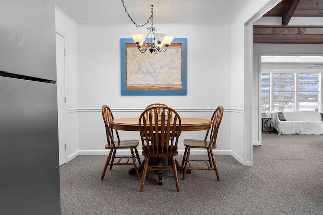 dining area featuring carpet and a notable chandelier