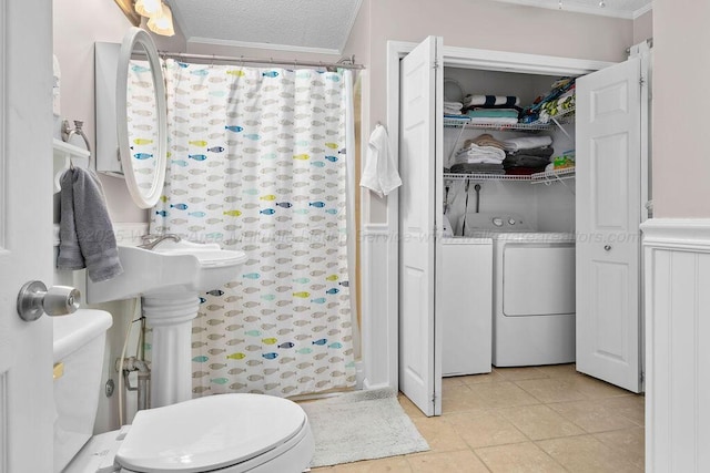 bathroom with separate washer and dryer, a textured ceiling, curtained shower, tile patterned floors, and toilet