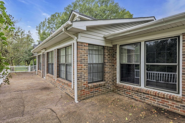 view of side of property with a patio area