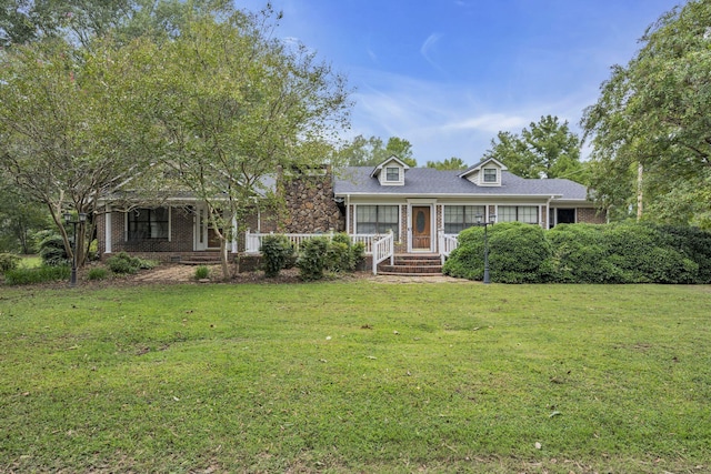 cape cod-style house featuring a porch and a front yard