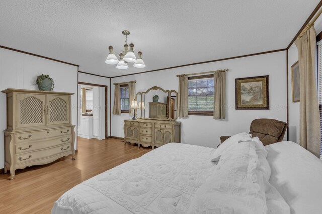 bedroom with a notable chandelier, crown molding, light hardwood / wood-style floors, and a textured ceiling