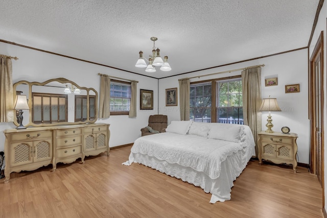 bedroom featuring crown molding, an inviting chandelier, a textured ceiling, and light wood-type flooring