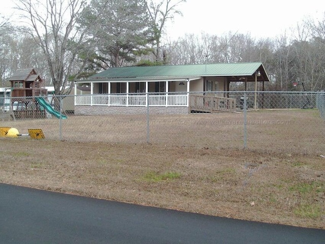 view of front of home featuring a playground and a porch