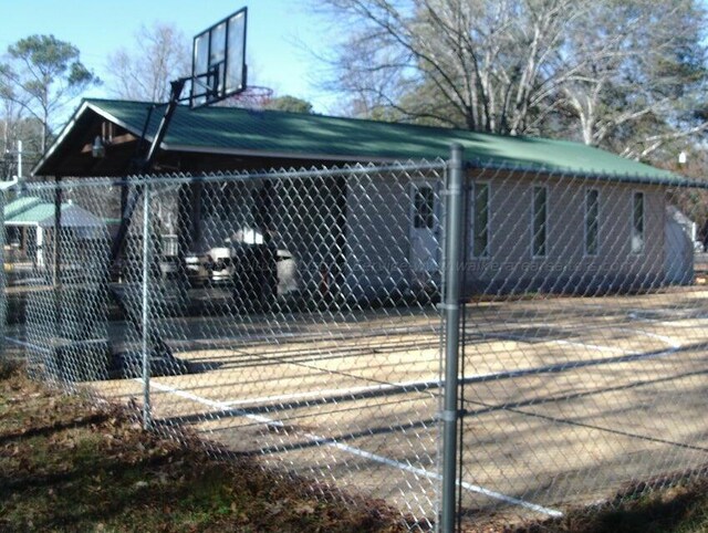 view of home's exterior featuring basketball court