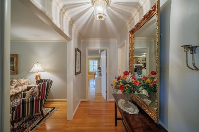 hall featuring light wood-type flooring and crown molding