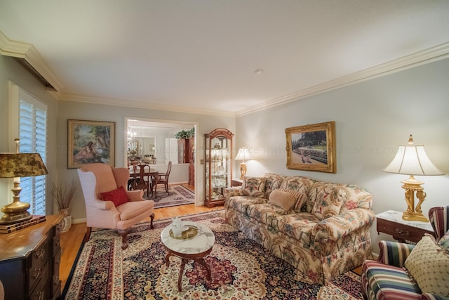 living room with hardwood / wood-style flooring and crown molding