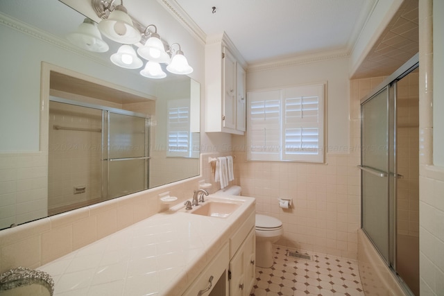 full bathroom with toilet, shower / bath combination with glass door, crown molding, and tile walls