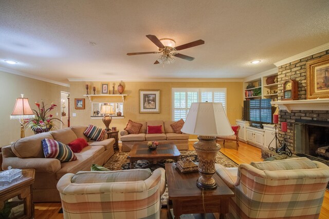 living room featuring a fireplace, crown molding, and light hardwood / wood-style flooring