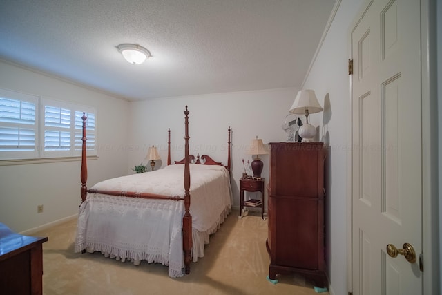 carpeted bedroom featuring a textured ceiling and ornamental molding