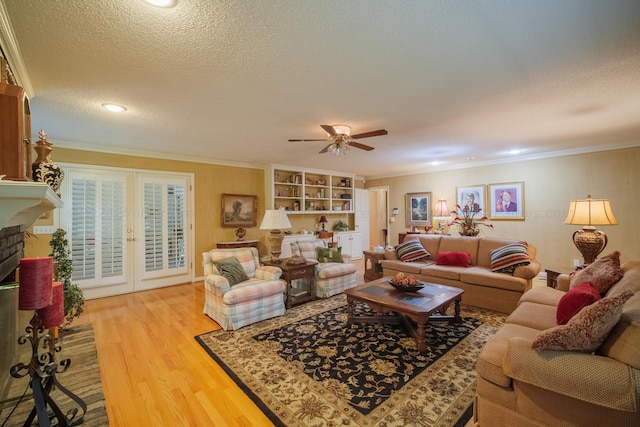 living room featuring french doors, ornamental molding, a textured ceiling, and hardwood / wood-style flooring