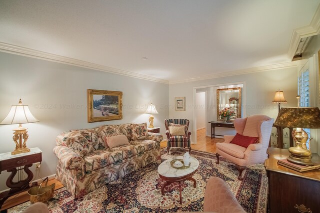 living room with hardwood / wood-style floors and crown molding