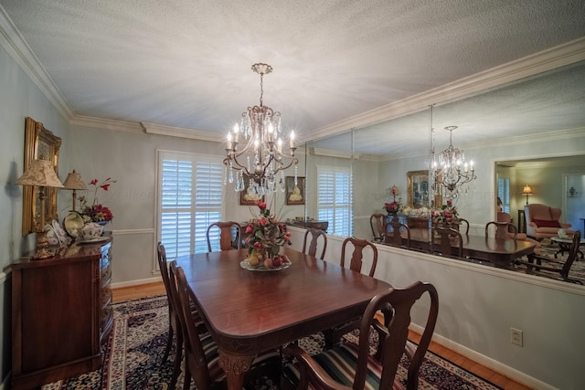 dining area with a wealth of natural light, crown molding, a chandelier, and hardwood / wood-style flooring