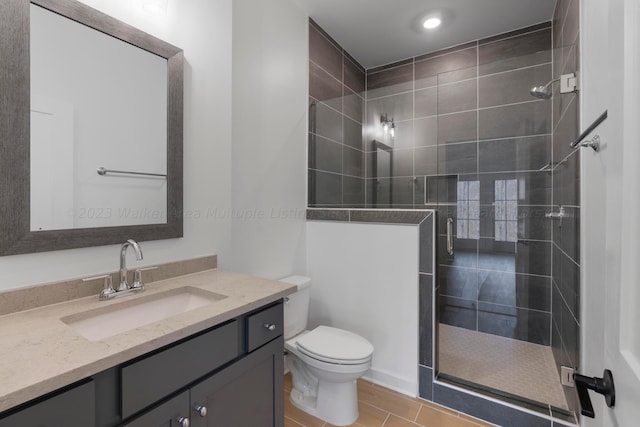 bathroom featuring vanity, toilet, and an enclosed shower