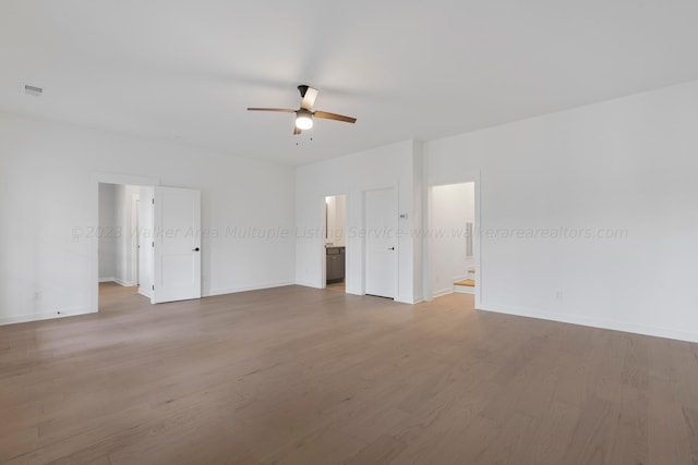 empty room with hardwood / wood-style flooring and ceiling fan