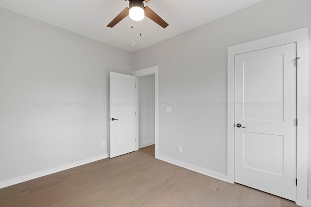 unfurnished room featuring ceiling fan and light wood-type flooring