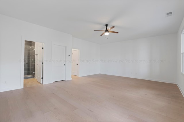 empty room featuring ceiling fan and light wood-type flooring