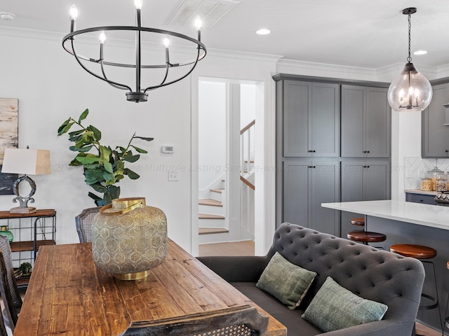 dining room featuring a chandelier and crown molding