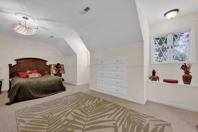 carpeted bedroom featuring lofted ceiling