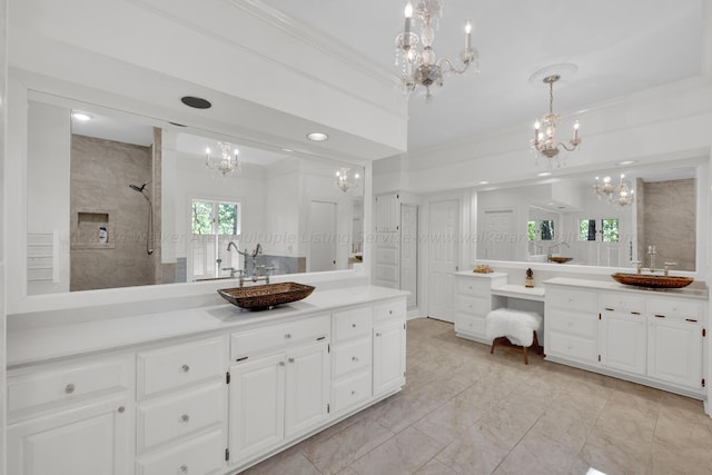 bathroom with a tile shower, crown molding, and vanity