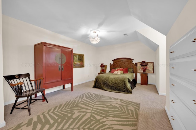 bedroom featuring light colored carpet and vaulted ceiling