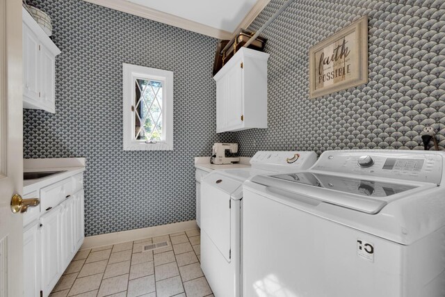 washroom with cabinets, crown molding, light tile patterned floors, and washer and dryer