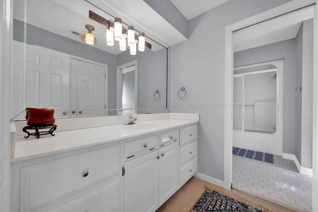 bathroom featuring vanity and a shower with door