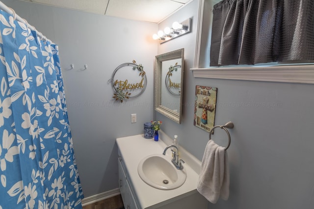 full bathroom with a shower with shower curtain and vanity