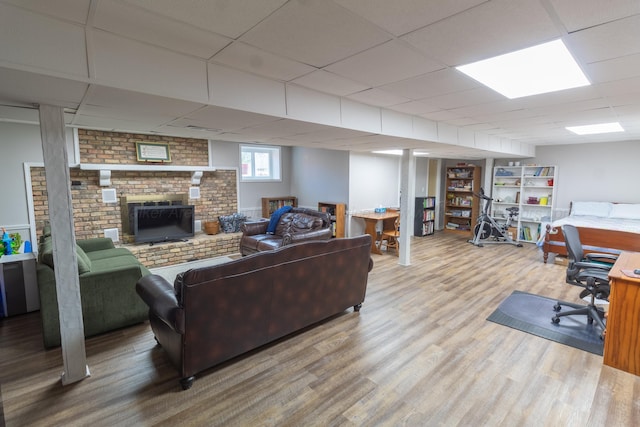 living room featuring a drop ceiling and wood finished floors