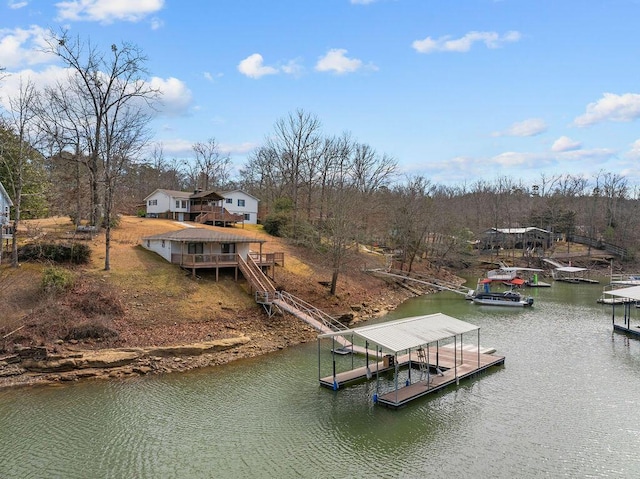 view of dock featuring stairway and a deck with water view