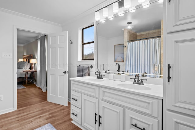 bathroom with vanity, hardwood / wood-style floors, crown molding, and walk in shower