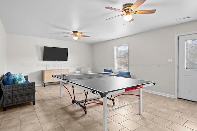 rec room featuring light tile patterned floors, visible vents, ceiling fan, and baseboards