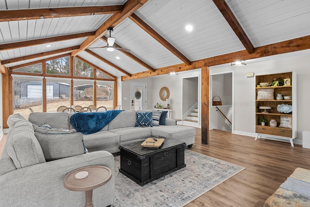 living room featuring hardwood / wood-style flooring, ceiling fan, high vaulted ceiling, and beamed ceiling